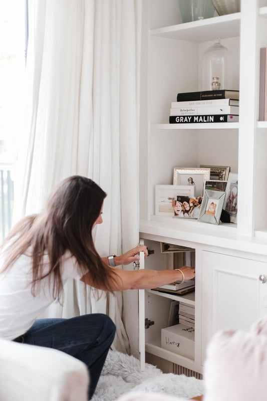 A woman organizing a cabinet